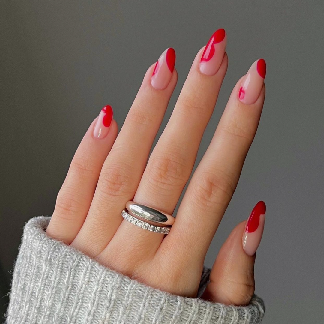 abstract red dots in shape of hearts on round beige nails