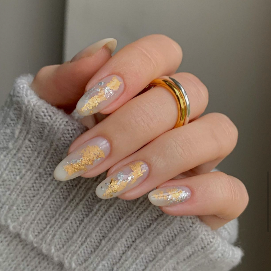 Gold and silver nail art on natural almond shaped nails