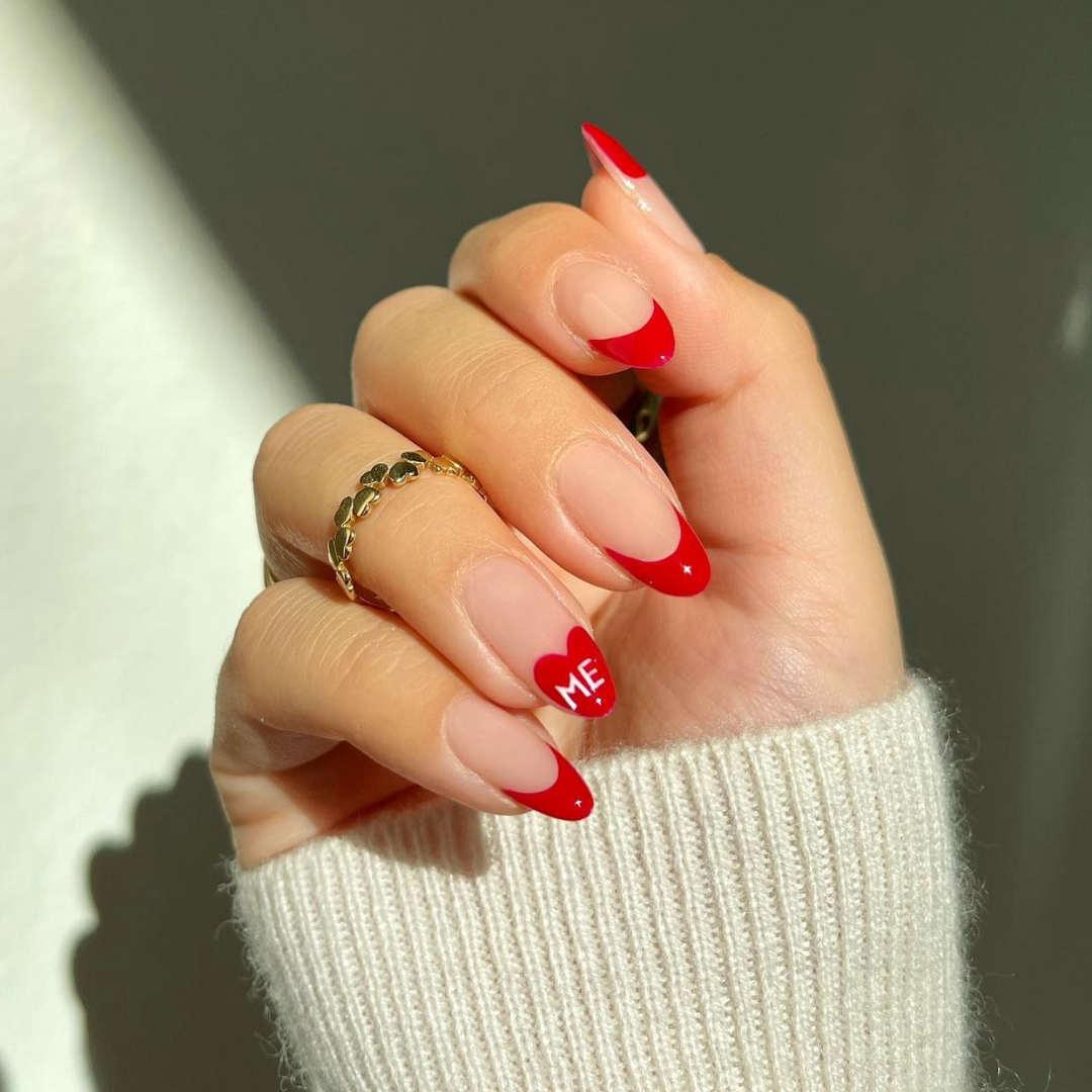 red french tip manicure on almond nails with ME written on ring finger