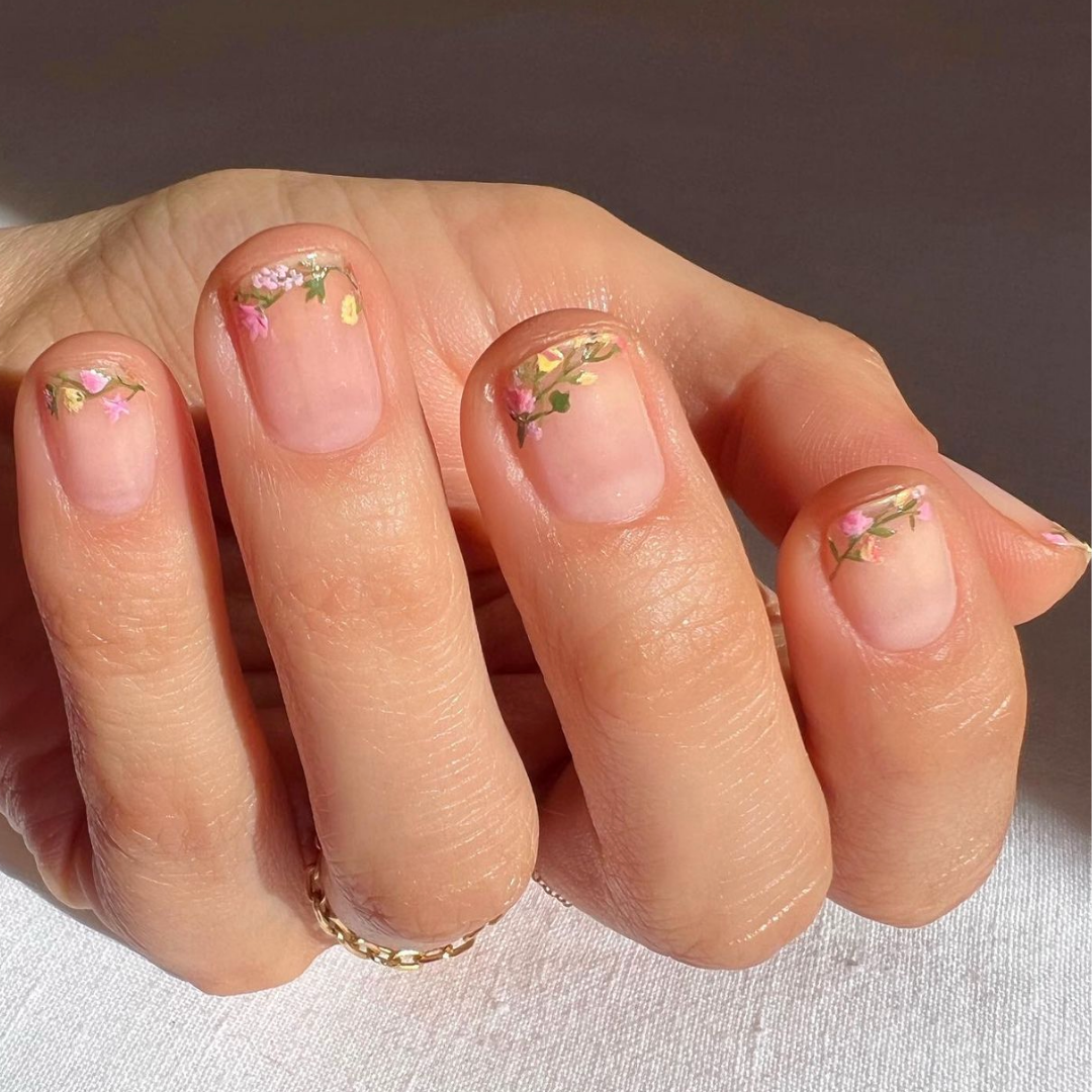 short natural manicured nails with hand drawn florals around the tips