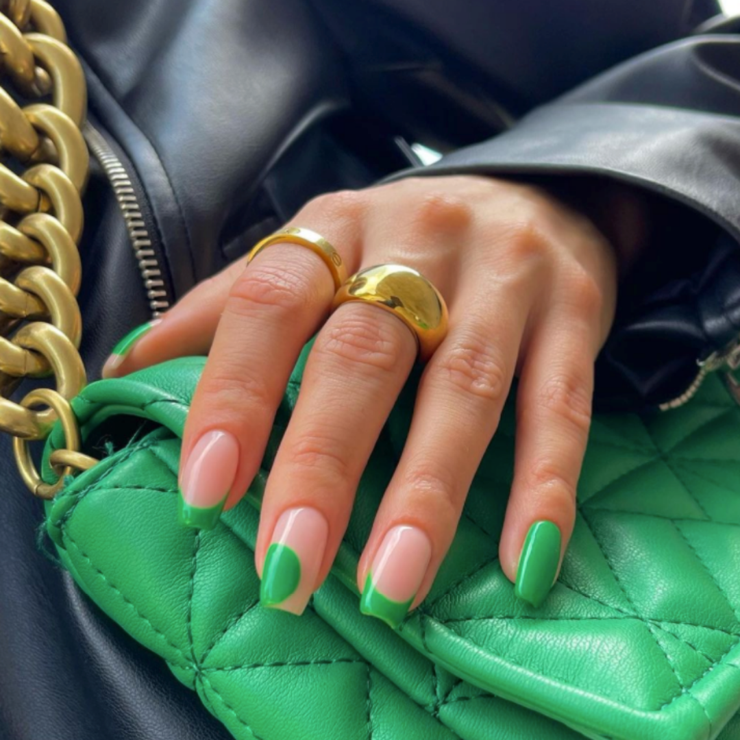 green purse with nude and green abstract nail design 