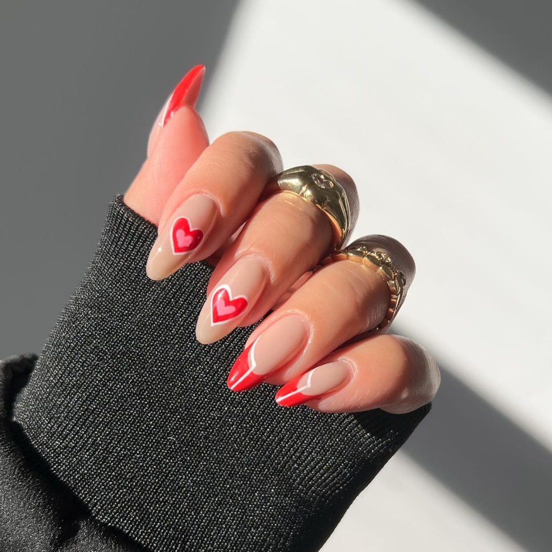 long almond nails with red outlined hearts 
