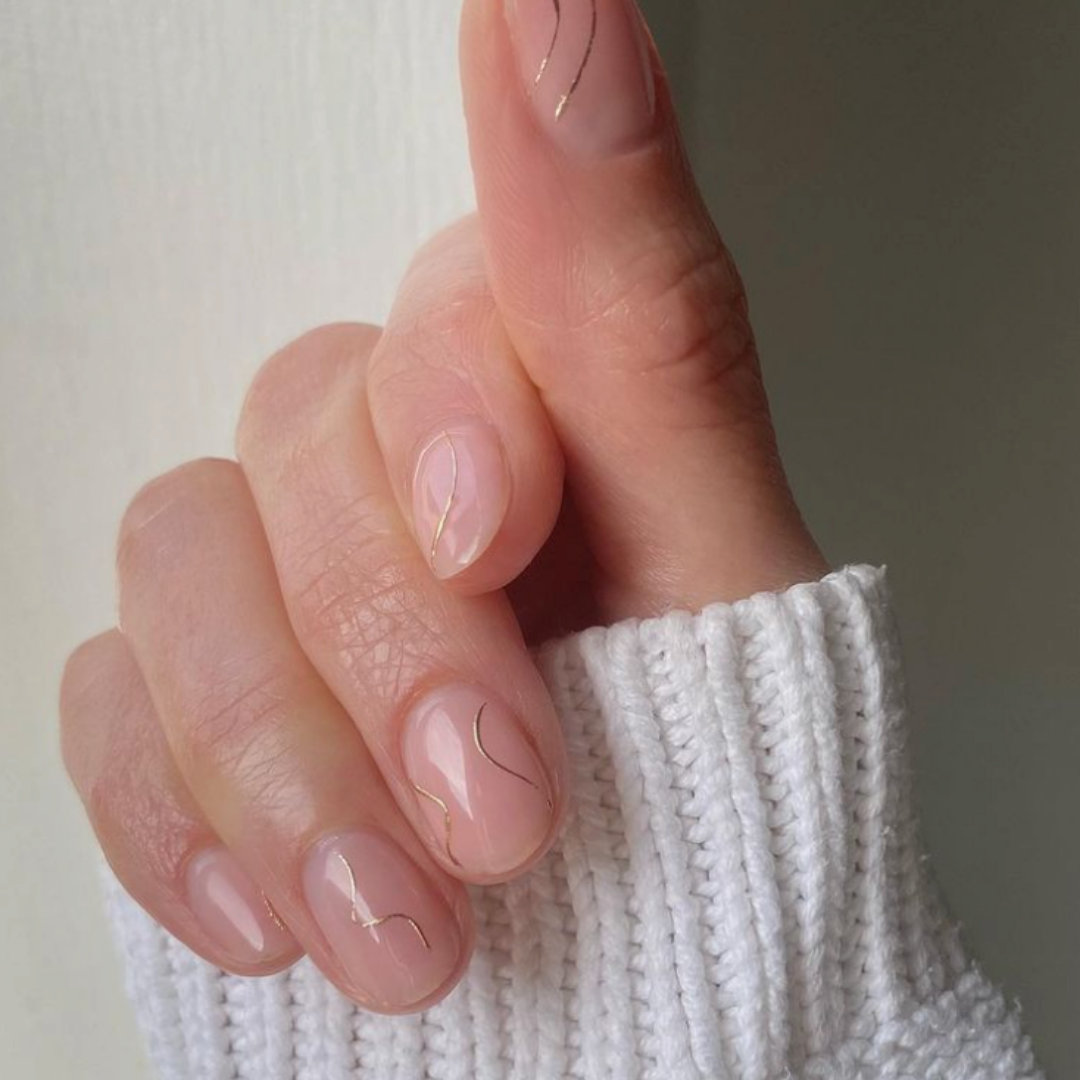 nude short round nails with gold thin lines 
