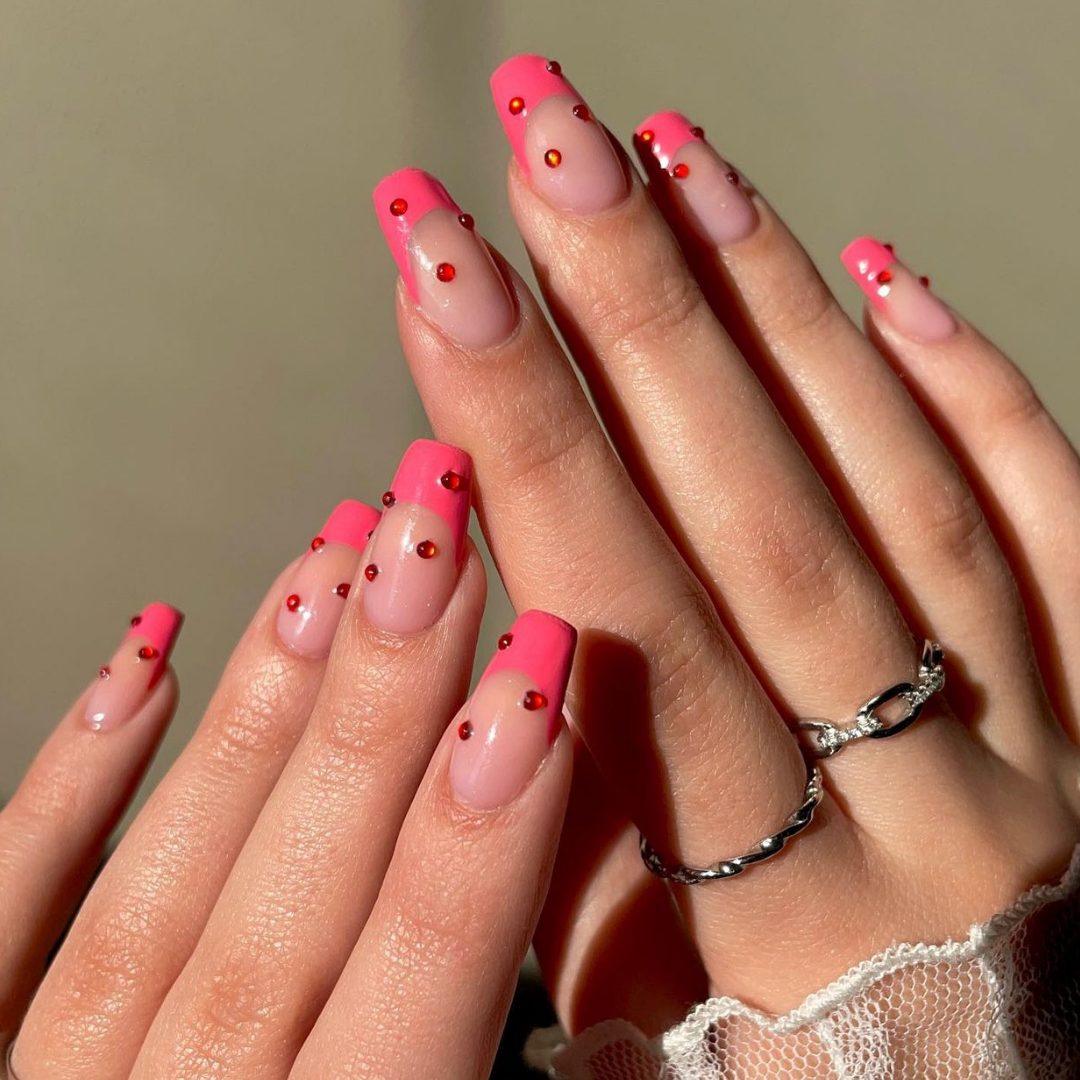 pink french tip manicure with red crystals 