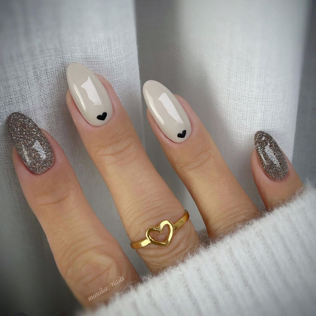 beige and grey glitter almond shaped nails with black hearts