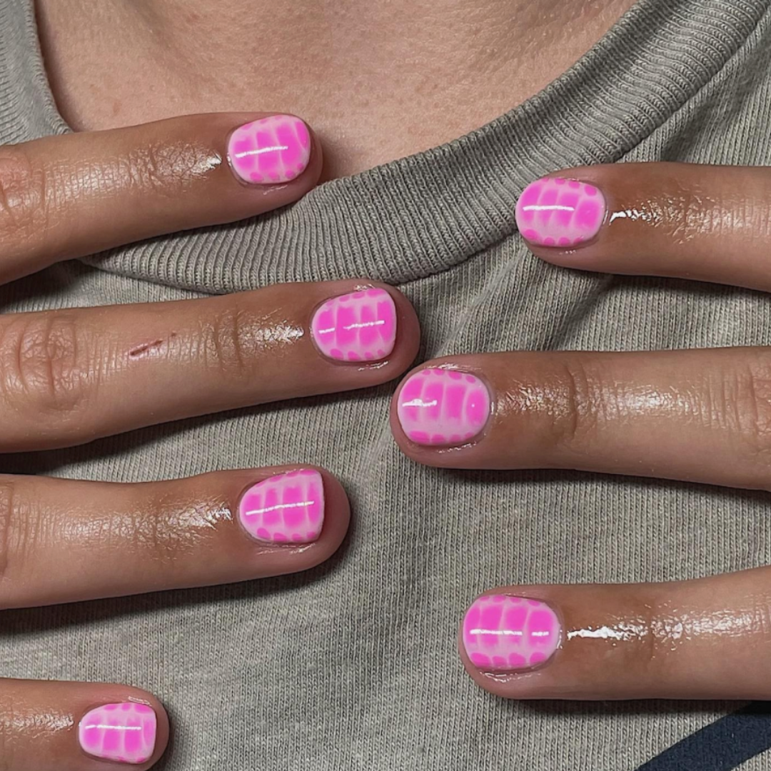 short bright pink nail with alligator print