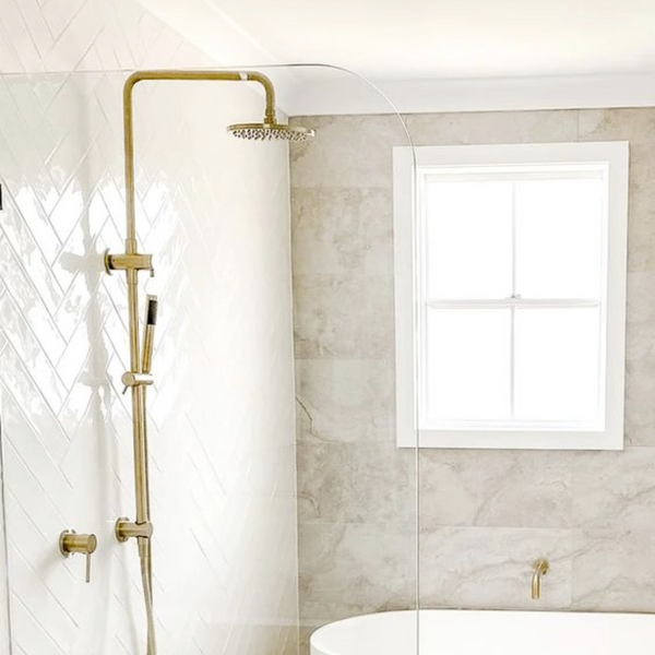 gold rainfall shower with white tiles