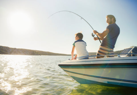Dad and son fishing on a boat | ITC Shop Now