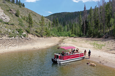 Pontoon Boat anchored on a beach on a sunny day | ITC Shop Now