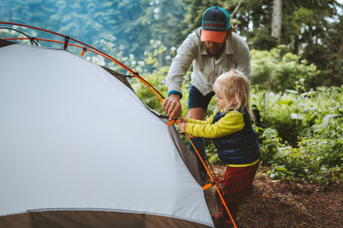 Father and Daughter set up a tent together
