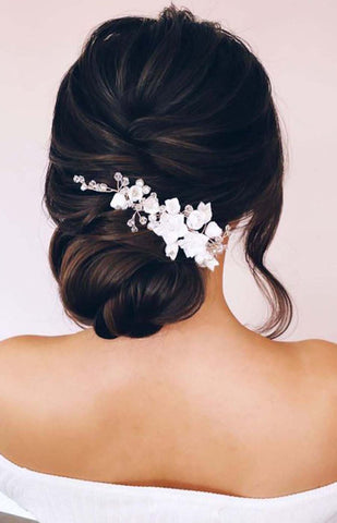4. Low Twisted Bun with Flowers