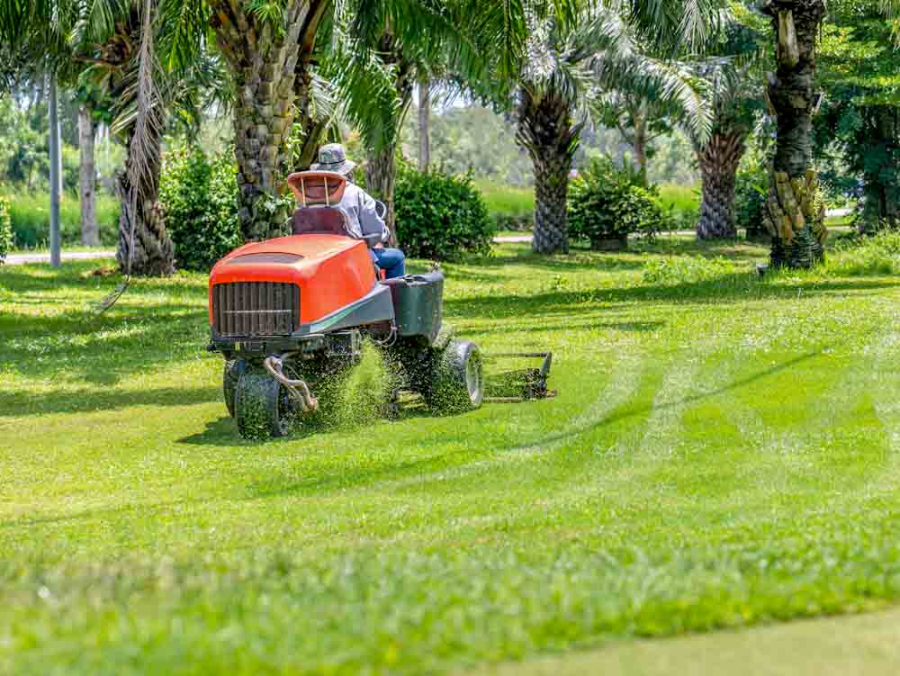 Mowing grass at golf course