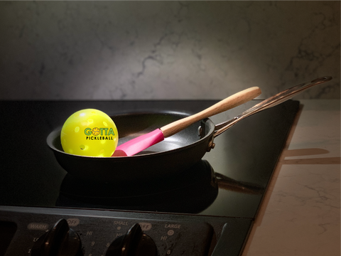 pickleball and spatula in a frying pan