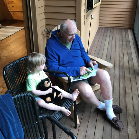 Karl Glocker reading to his grandson