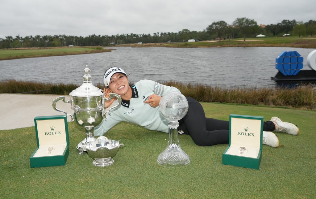 Lydia posing with trophies 