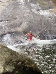 photo of young girl plunging into mountain stream at Sliding Rock natural waterslide 