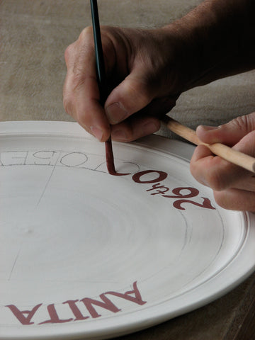 hand lettering on pottery