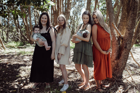 Pregnant ladies wearing maternity dresses that are breastfeeding friendly 