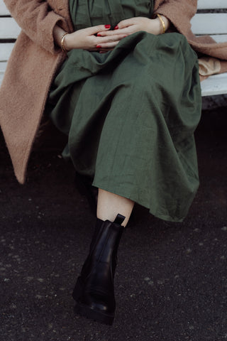green maternity dress worn with boots