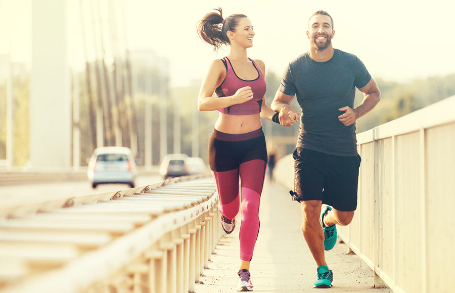 Couple running over a bridge