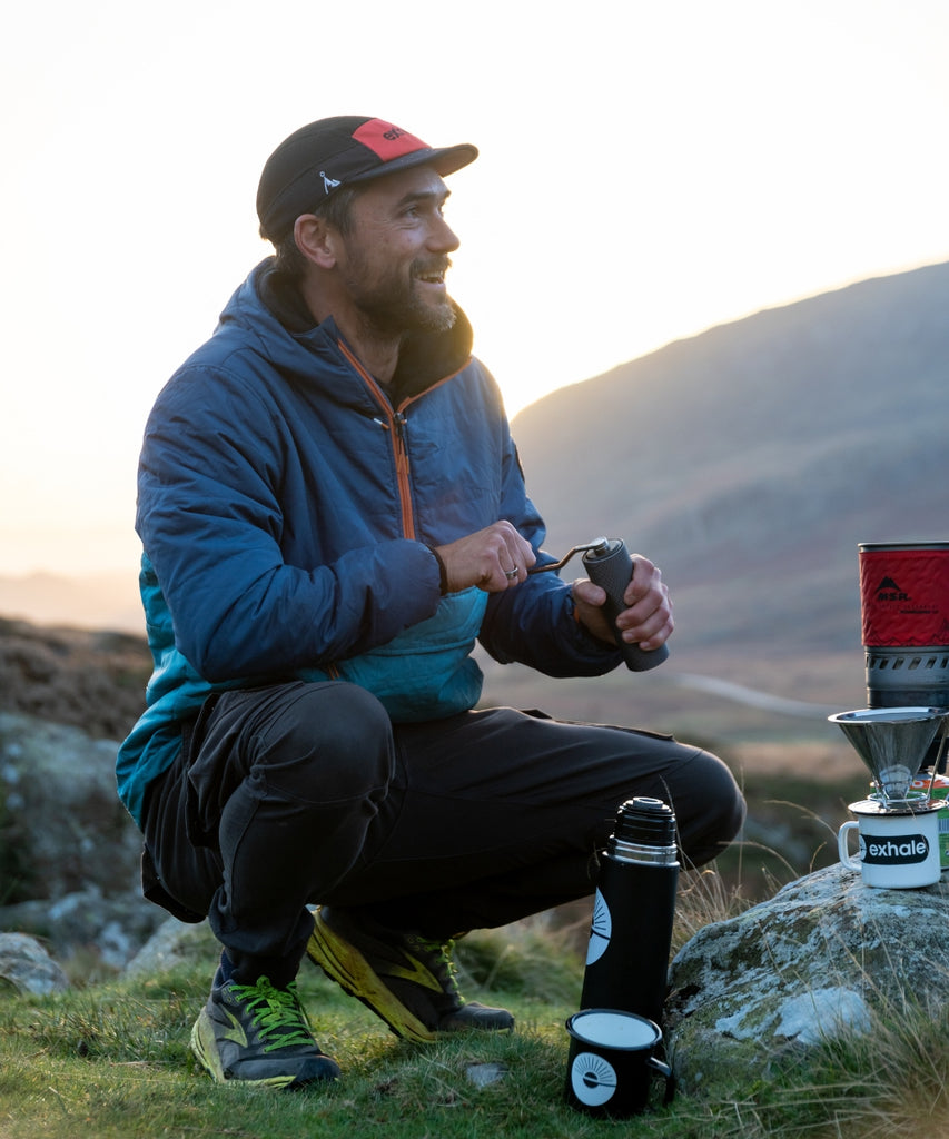 Exhale Healthy Coffee being ground by a smiling gentleman - Exhale Founder Al