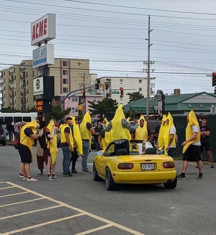 the famous bananas of h2o surrounding and praising a auto enthusiast in a yellow miata