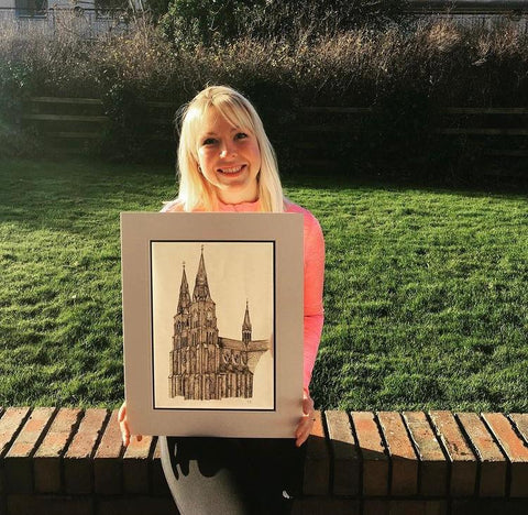 Gail holding her drawing of a church
