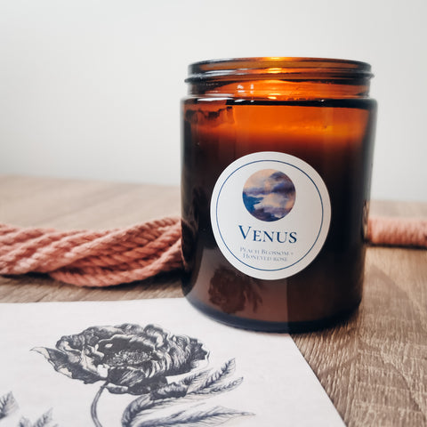 candle with rose and pink rope in background