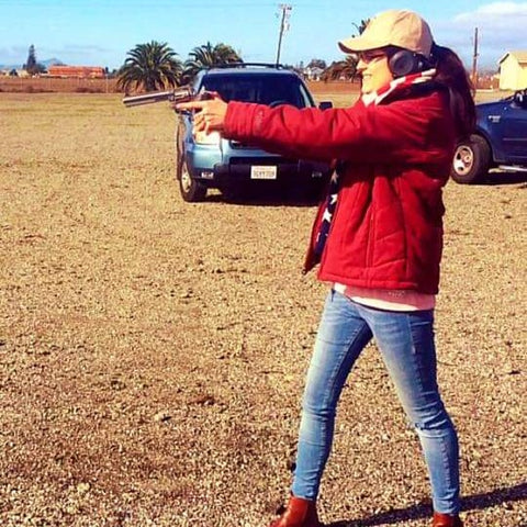 Girl aiming with a hand gun