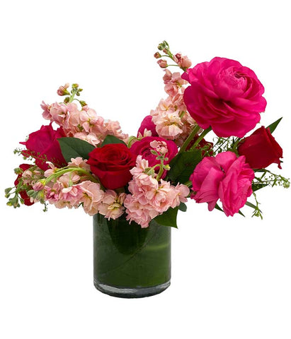 An asymmetrical pink, magenta, and red floral arrangement by H.Bloom, called Crazy Love.