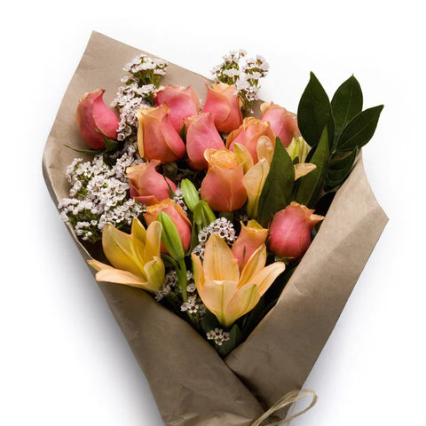 Floral bouquet of peach roses and yellow lilies