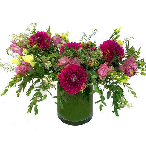 A whimsical magenta floral arrangement with dahlias by H.Bloom, called Strawberry Fields.