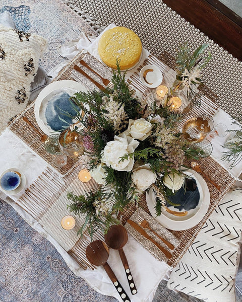 A tablescape featuring mixed materials and textures, featuring premium floral arrangement from H.Bloom.