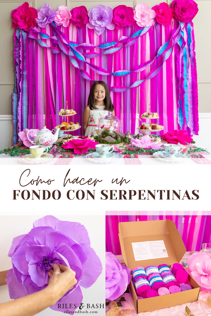 El kit de telón de fondo con serpentina rosa y morado encantado con flores de papel crepé de Riles & Bash es un telón de fondo vibrante para cualquier fiesta.