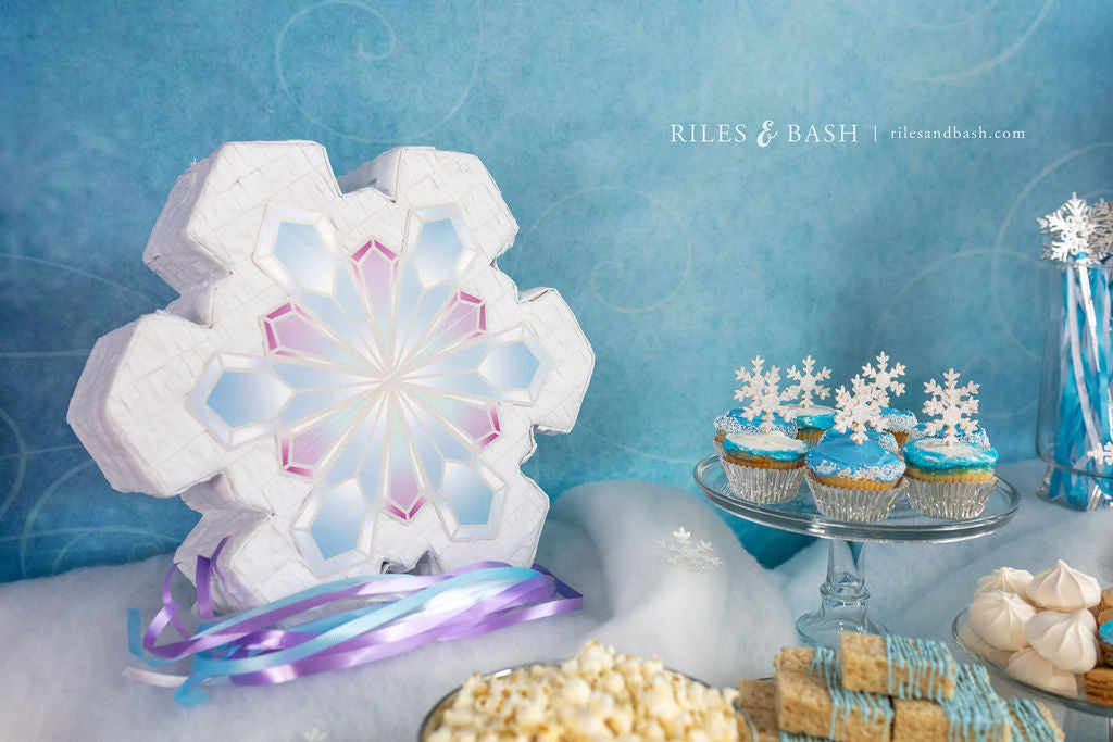 https://cdn.shopify.com/s/files/1/0263/7745/3614/files/Riles_Bash_Frozen_Snowflake_Pinata_Birthday_Party_Pinata_Winter_Wonderland_Christmas_Pinata_MG_9157-whiter-wm_1024x1024.jpg?v=1642571059