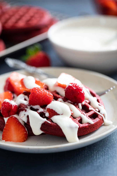 Vanilla Cream drizzled over red velvet waffles_photo taste and tell