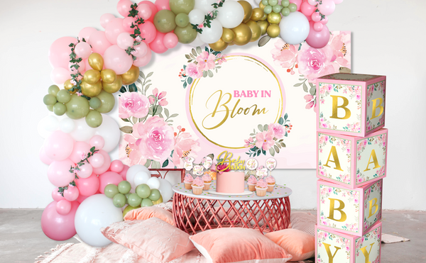 Floral Baby Shower Decoration set that contains the following:  Balloon Arch Garland Pink and Sage Green,  Baby Boxes with Letters, Oxford Cloth Backdrop, "Baby in Bloom" gold glitter cake topper and cupcake toppers, Satin Sash, FLOWER CONFETTI, Artificial Flowers Garland