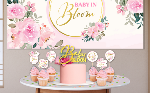 Floral Baby Shower Decoration set that contains the following:  Balloon Arch Garland Pink and Sage Green,  Baby Boxes with Letters, Oxford Cloth Backdrop, "Baby in Bloom" gold glitter cake topper and cupcake toppers, Satin Sash, FLOWER CONFETTI, Artificial Flowers Garland