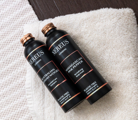 Nereus London Essential Care Shampoo and Conditioner placed on a towel