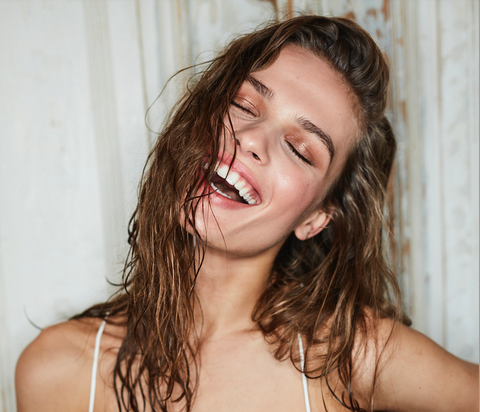 Woman smiling with partially wet hair