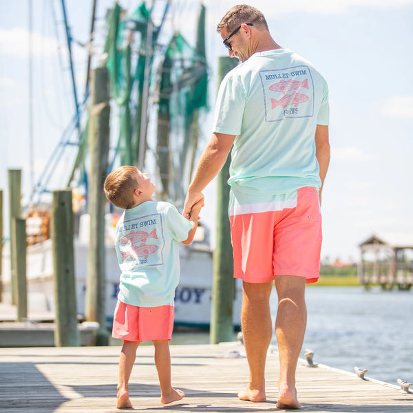 father and son walking down the boardwalk -  - Shrimp and Grits Kids Clothing Gives Back