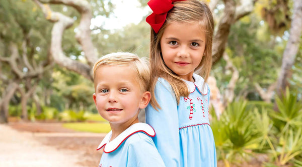 brother and sister in Christmas outfits smiling at the camera - Downloadable Christmas Gift Tags and Notecards