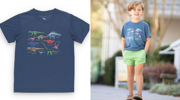 little boy wearing a fish graphic tee holding with his hands in his pickets standing on the sidewalk