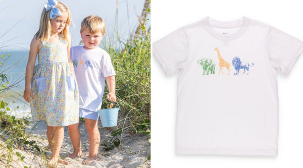 little boy in a graphic tee design and little girl walking through the sand dunes