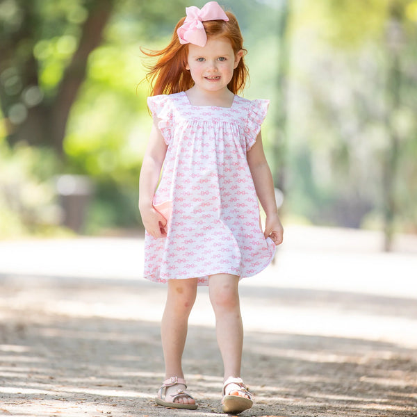 precious little girl walking down the street in the katy hope dress