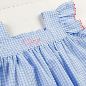 happydays font monogrammed on a blue check girl's dress