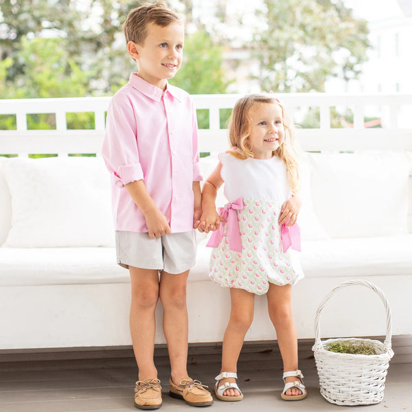 brother and sister on porch in Easter outfits