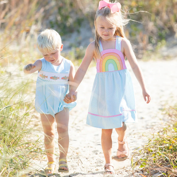 brother and sister holding hands in adorable outfits