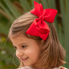 red biggie bow in little girl's hair