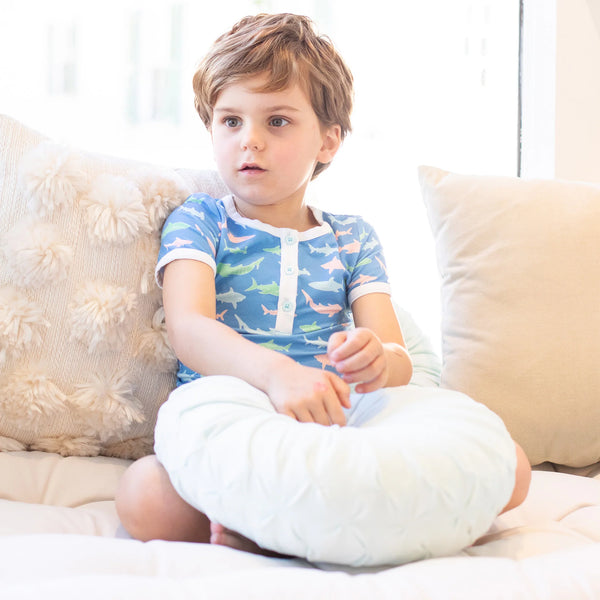 little boy in pajamas sitting on the couch